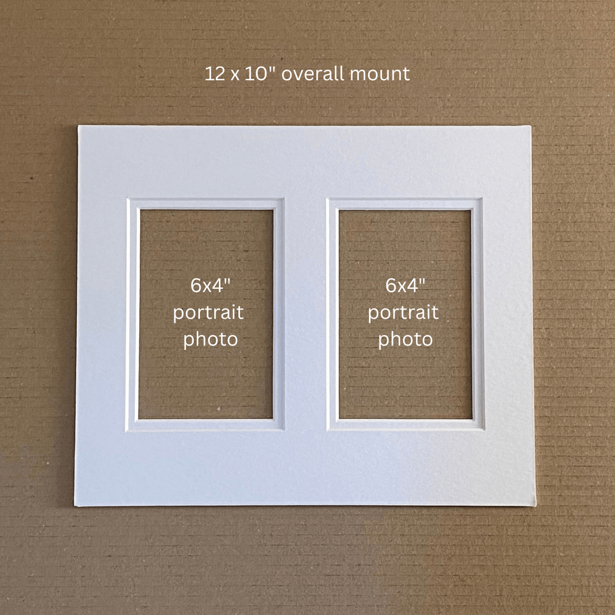 A white double-photo mount with two 6x4 portrait photo slots, shown on a brown textured background with text reading '12 x 10" overall mount' and '6x4" portrait photo' inside the slots.