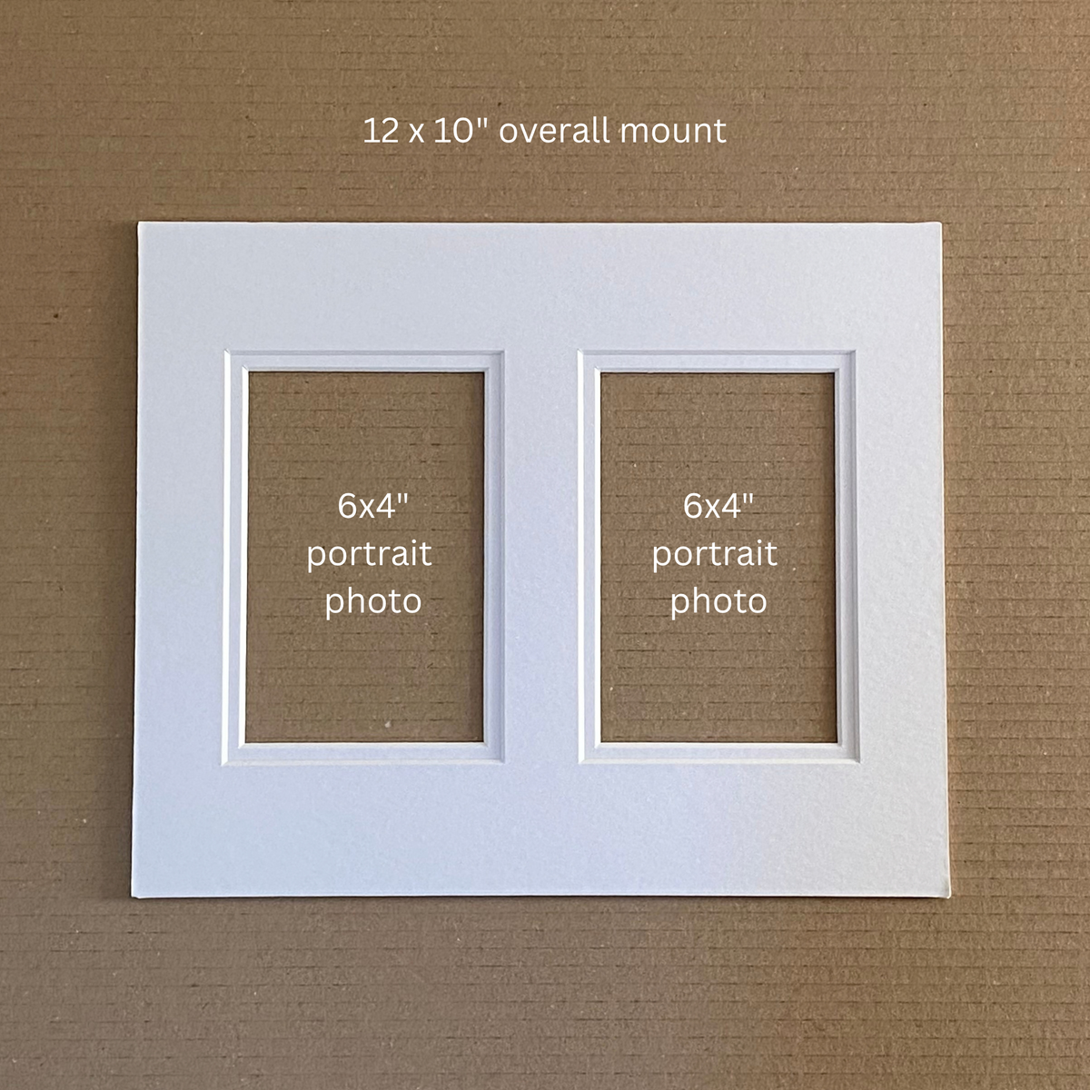 A white double-photo mount with two 6x4 portrait photo slots, shown on a brown textured background with text reading '12 x 10" overall mount' and '6x4" portrait photo' inside the slots.