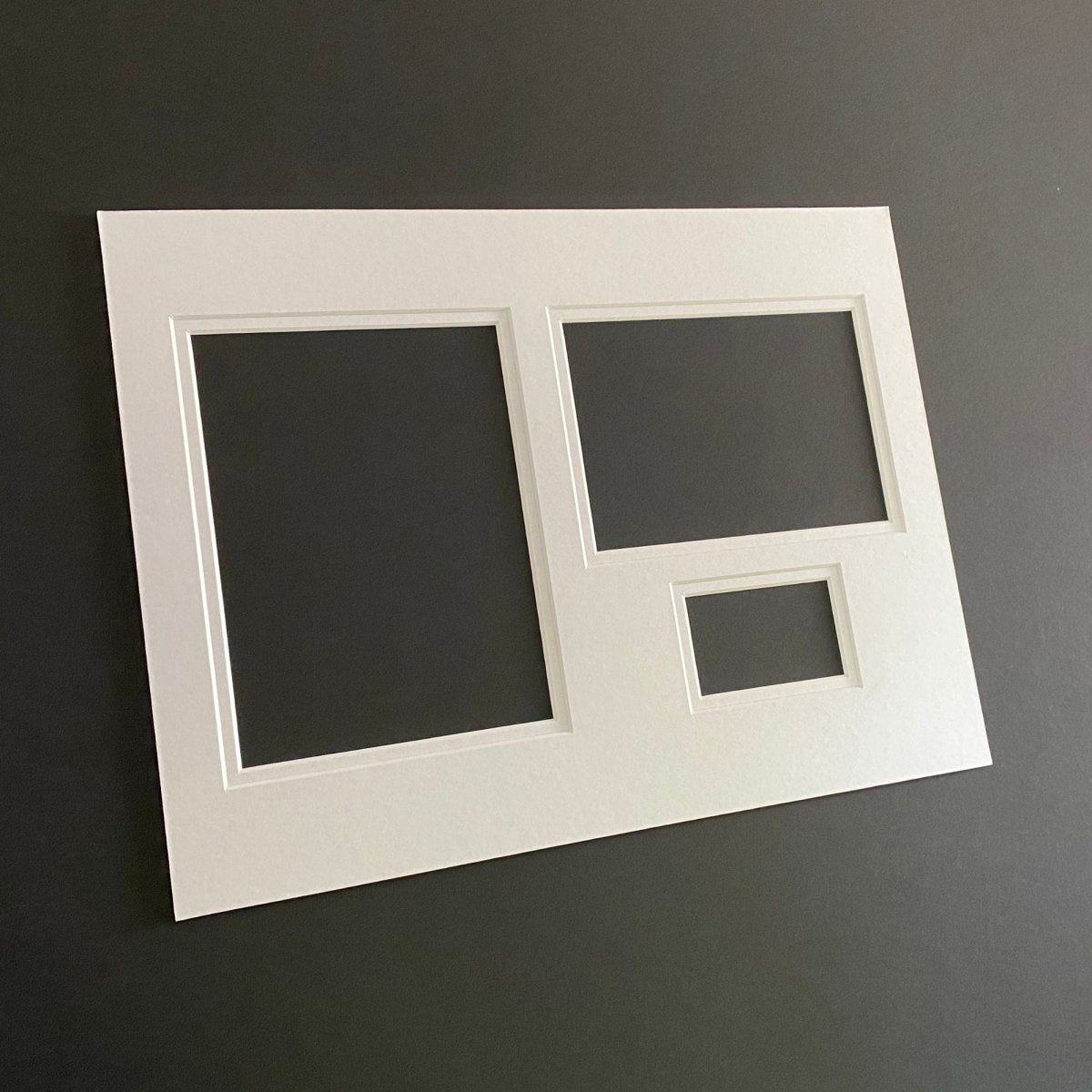 Large white 3-aperture picture double-mount on black background