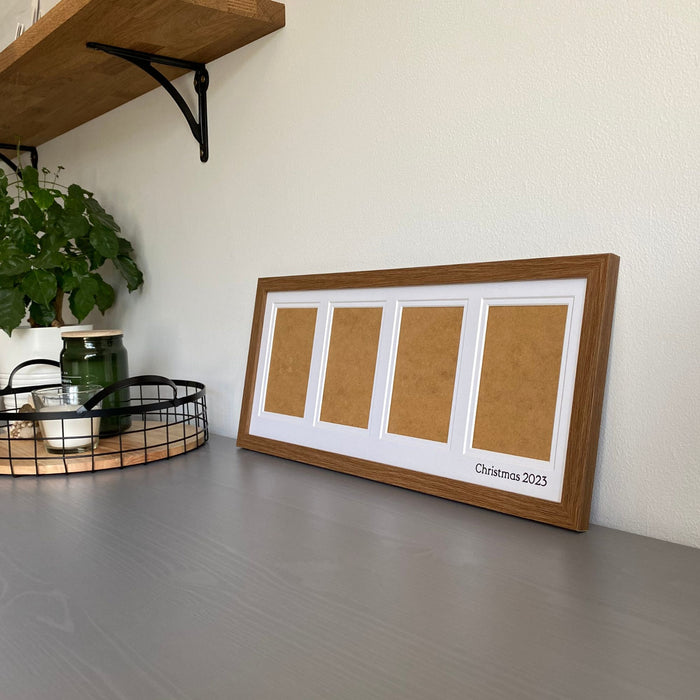 Dark Brown Multipicture Photo Frame for 4 Photos on grey dresser next to black mesh tray and candles and plant. Example of the personalisation to be inscribed on the white mount - Azana Photo Frames