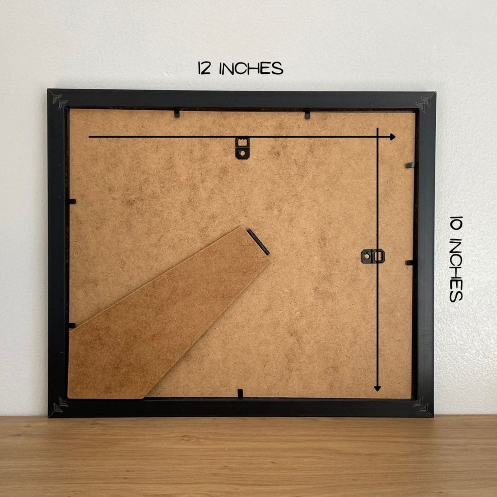 Back of a framed picture with measurements on a white wall