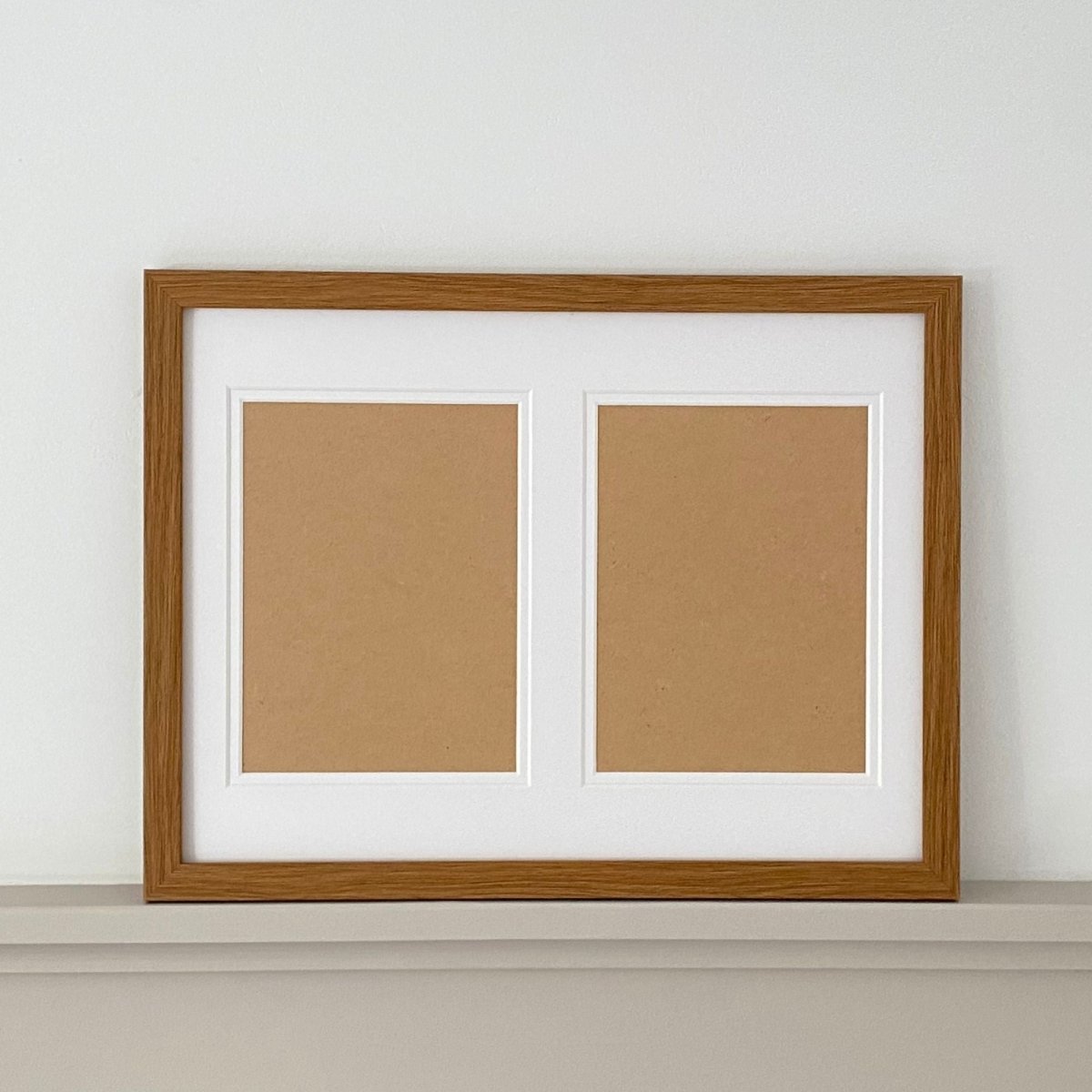 Large Brown framed, two aperture white mount on a grey shelf - Azana Photo Frames