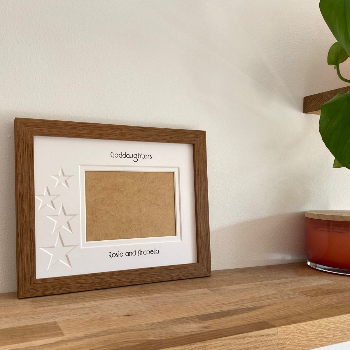 Brown 1-aperture picture frame displaying an empty photo on wooden shelf