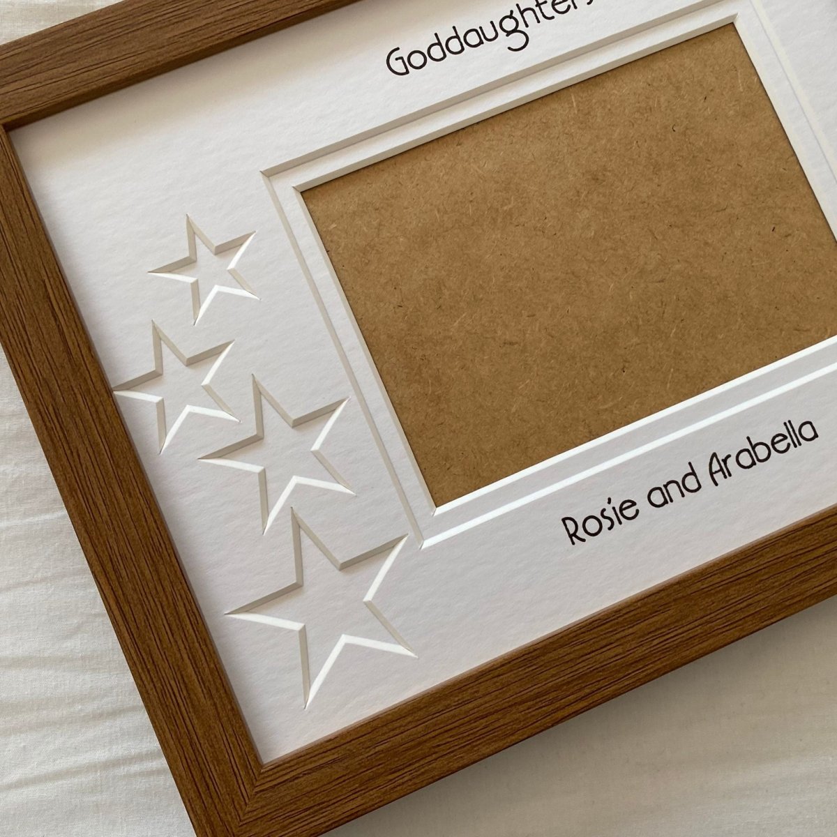 Brown landscape picture frame displaying star-shaped cut-outs