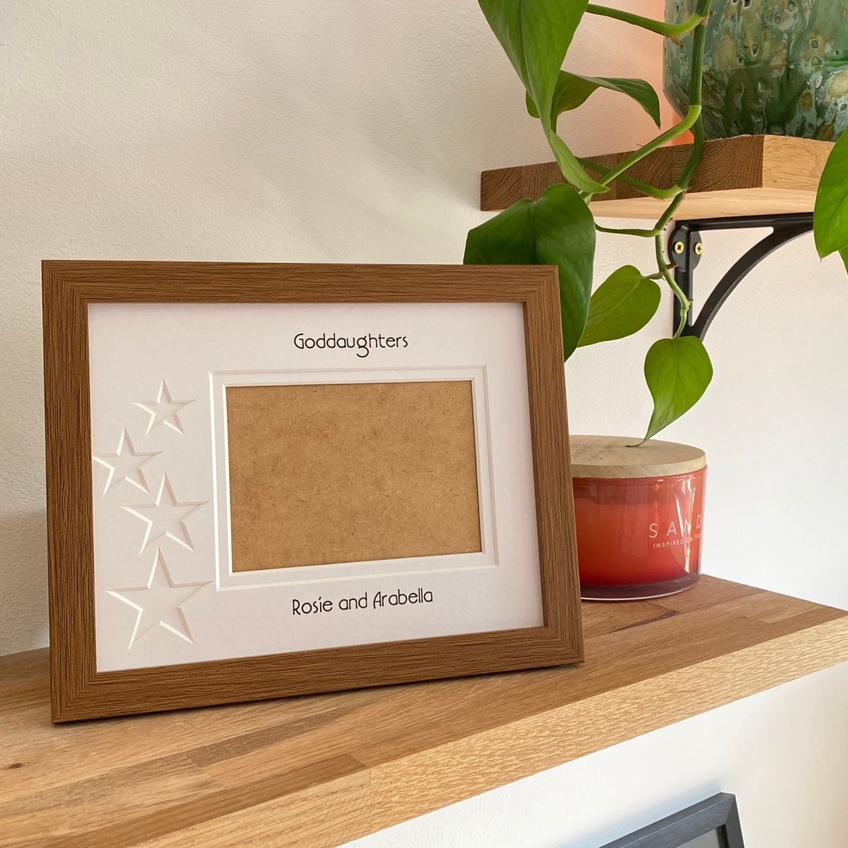 Brown 1-aperture picture frame displaying a family photo on wooden shelf