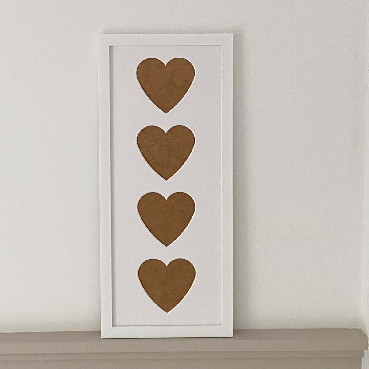White heart apertures frame on shelf against a wall - Azana Photo Frames