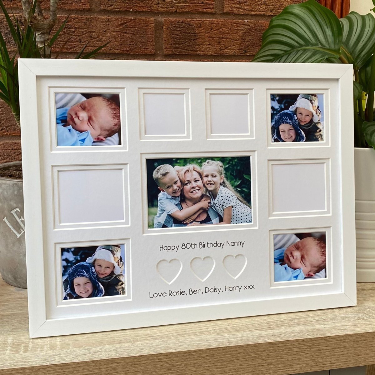 Custom message white frame on table top and plants