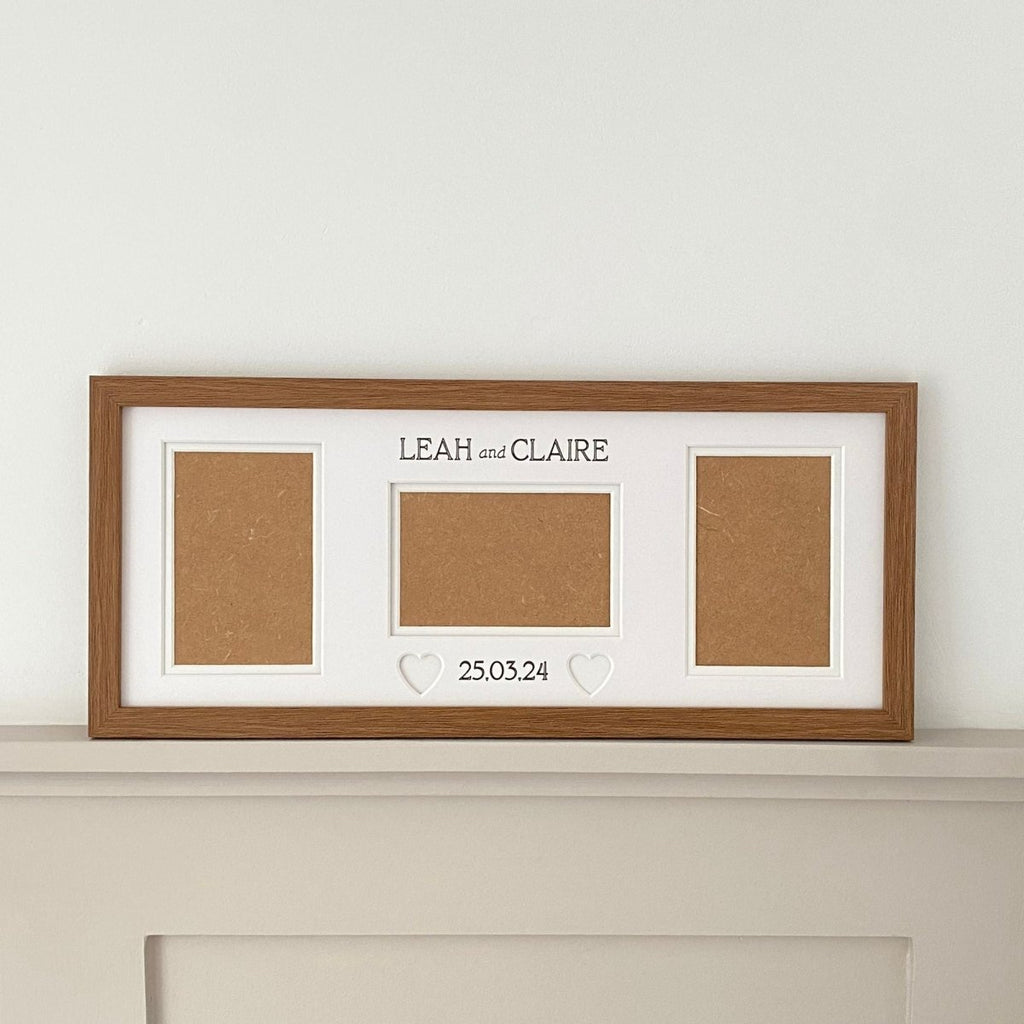 Oblong dark brown wedding frame on shelf