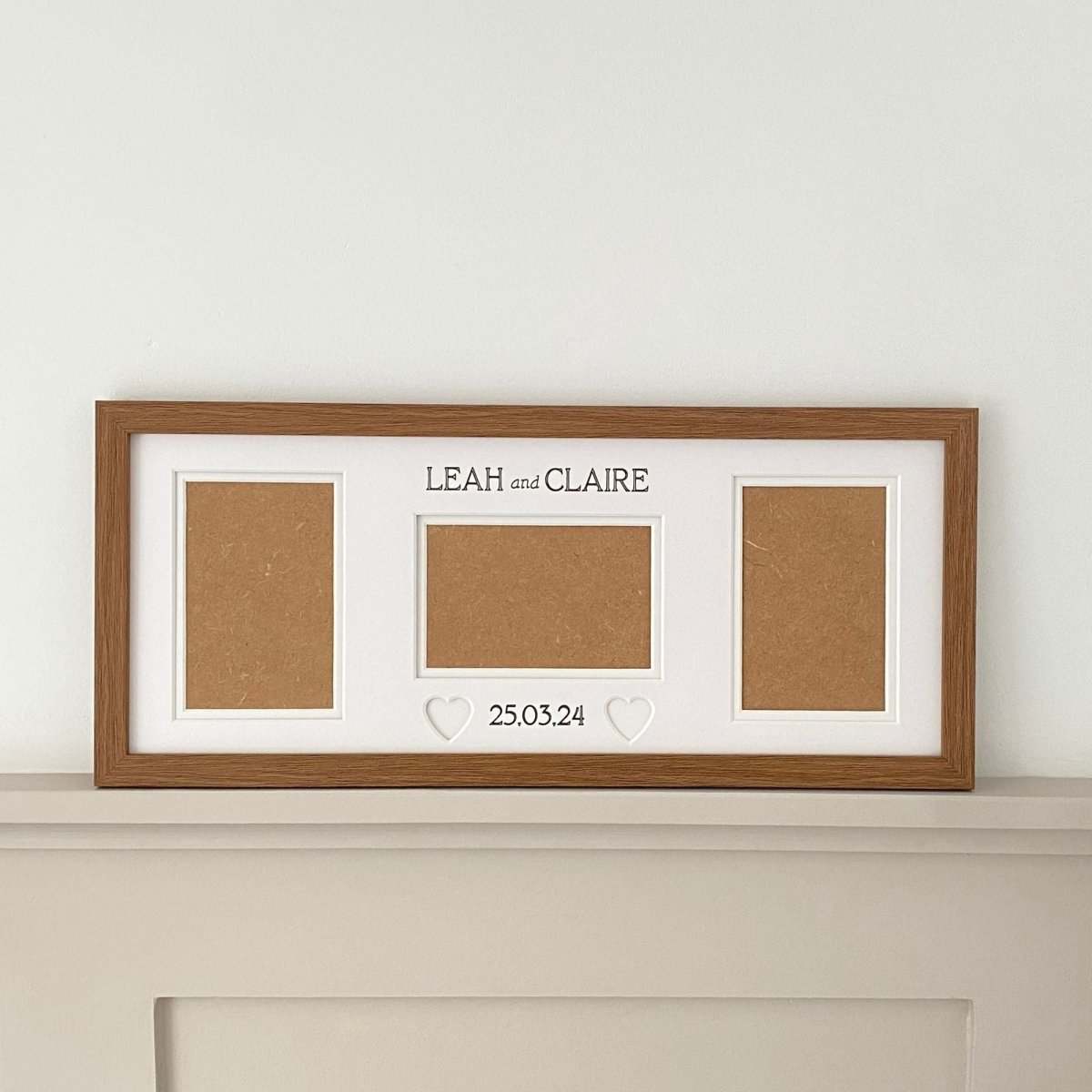 Oblong dark brown wedding frame on shelf