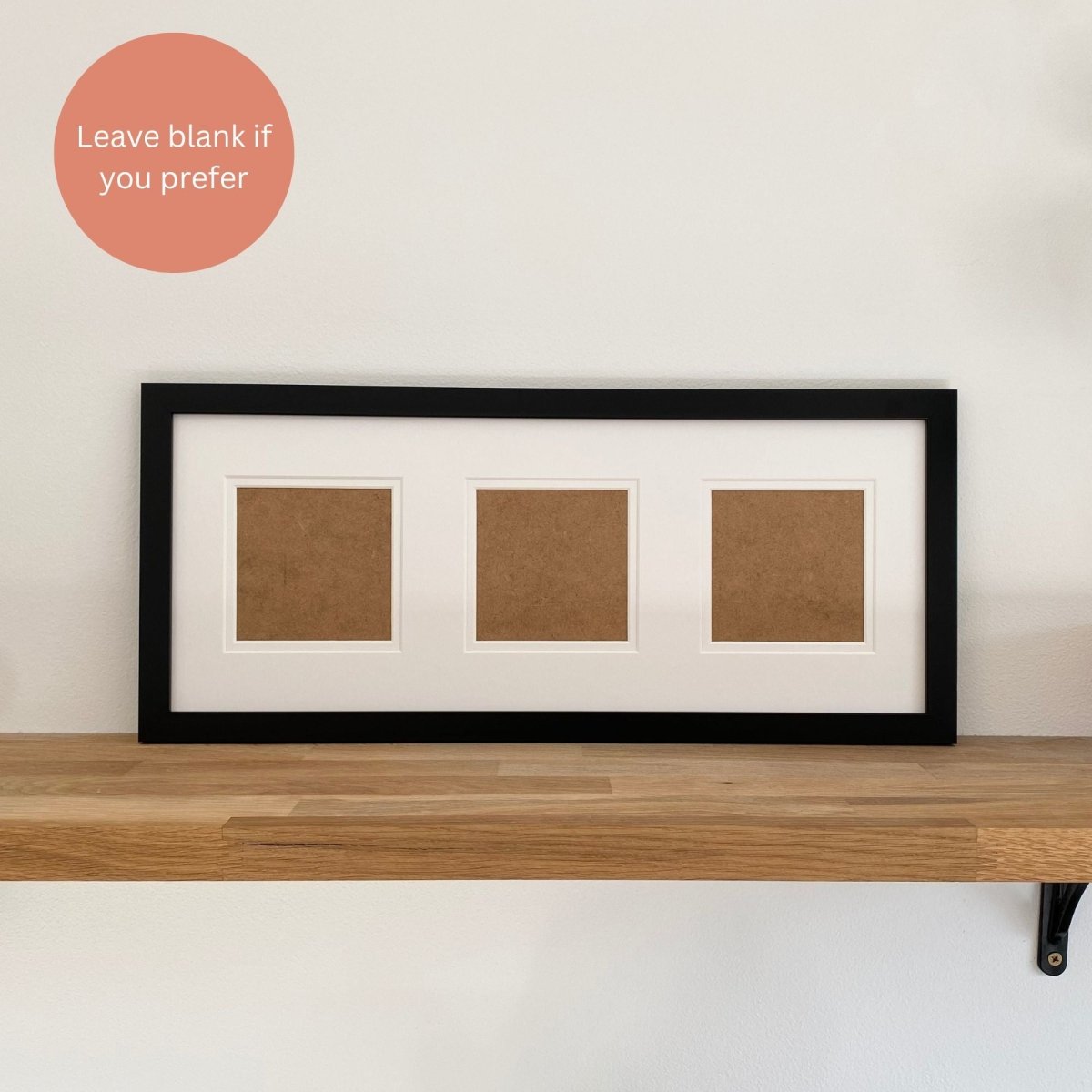Black frame white multipicture mount on brown wooden shelf, white background