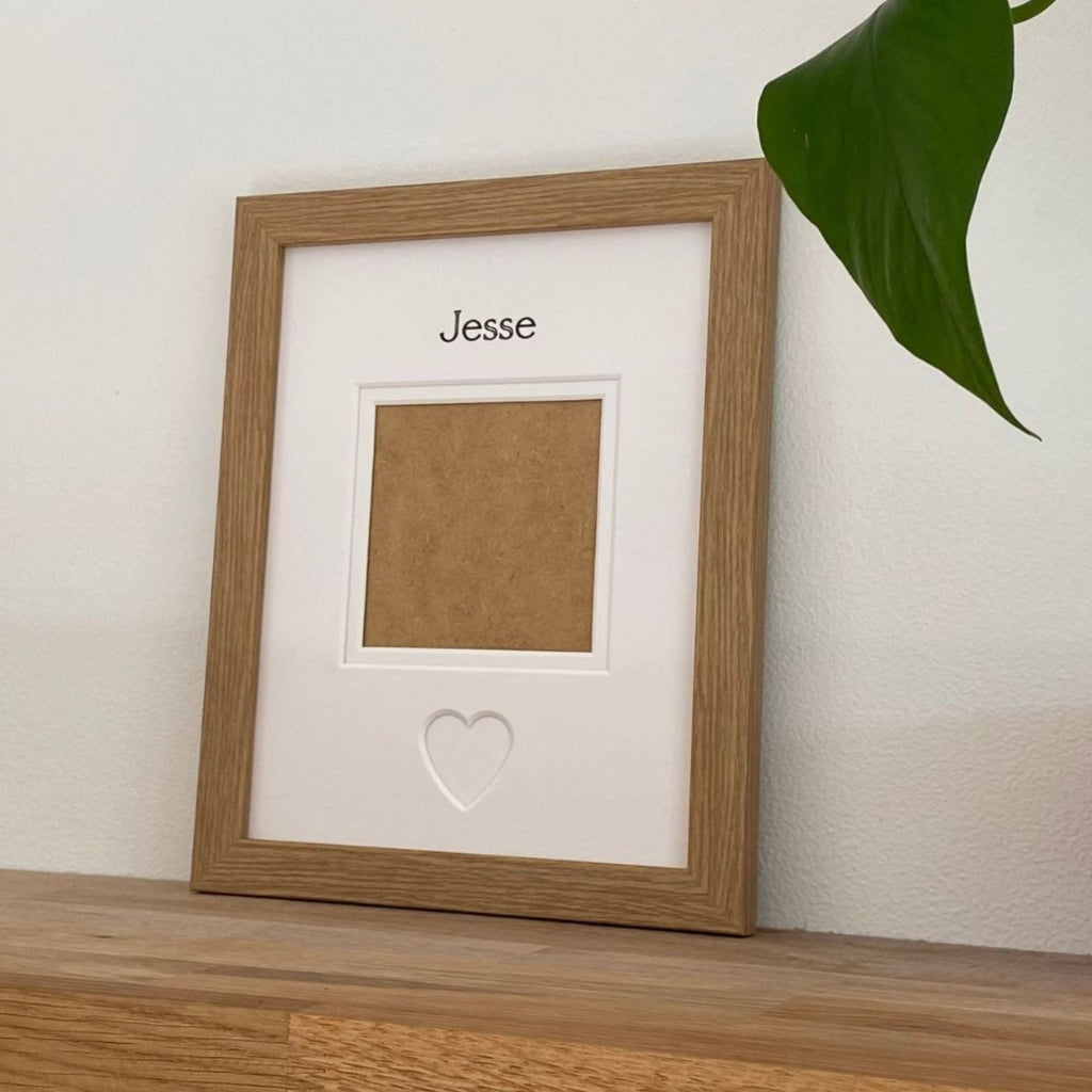 Light brown 1-aperture picture frame displaying a pet photo on wooden shelf