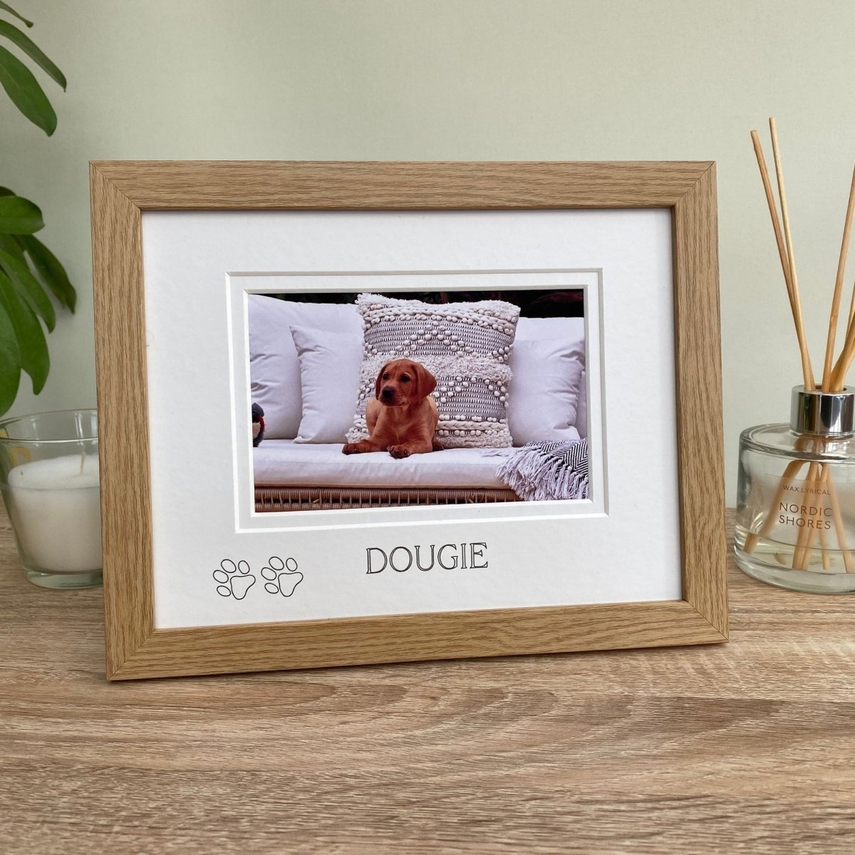 Wooden photo frame with a picture of a dog named Dougie on a neutral background