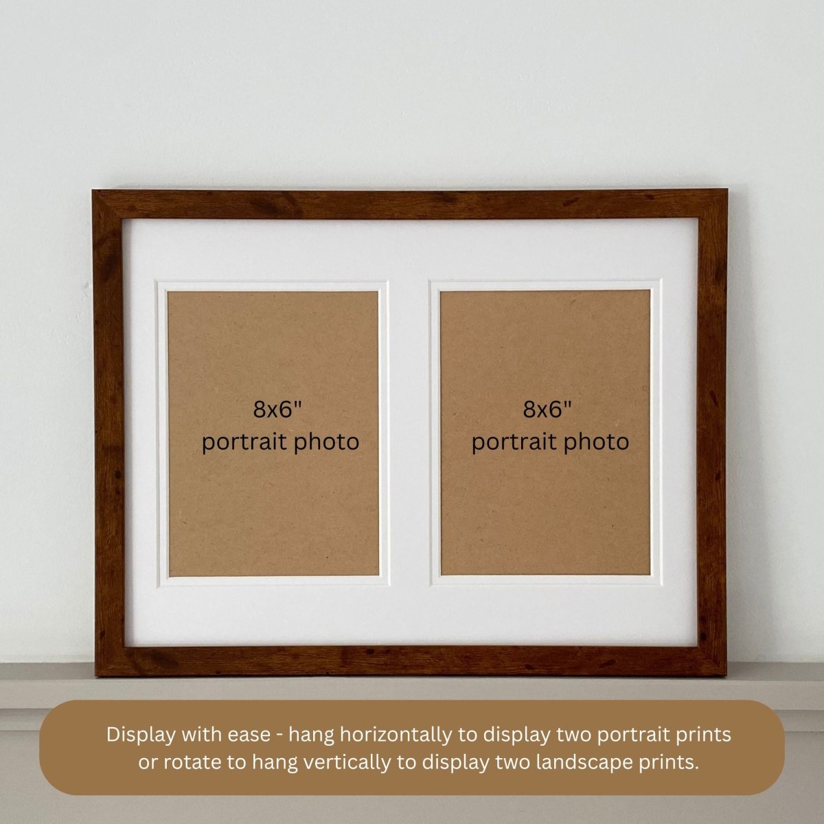 Double aperture white mount in a teak frame on light grey shelf and information about wall hanging orientation.