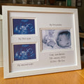 Framed baby photo album with ultrasound images and text on a wooden surface