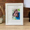 White portrait, single aperture picture frame star design on wooden table