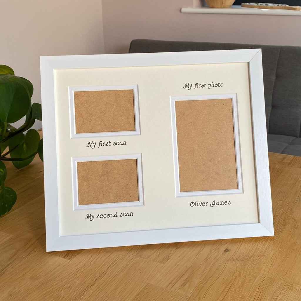 White photo frame with three apertures and text on a wooden surface.