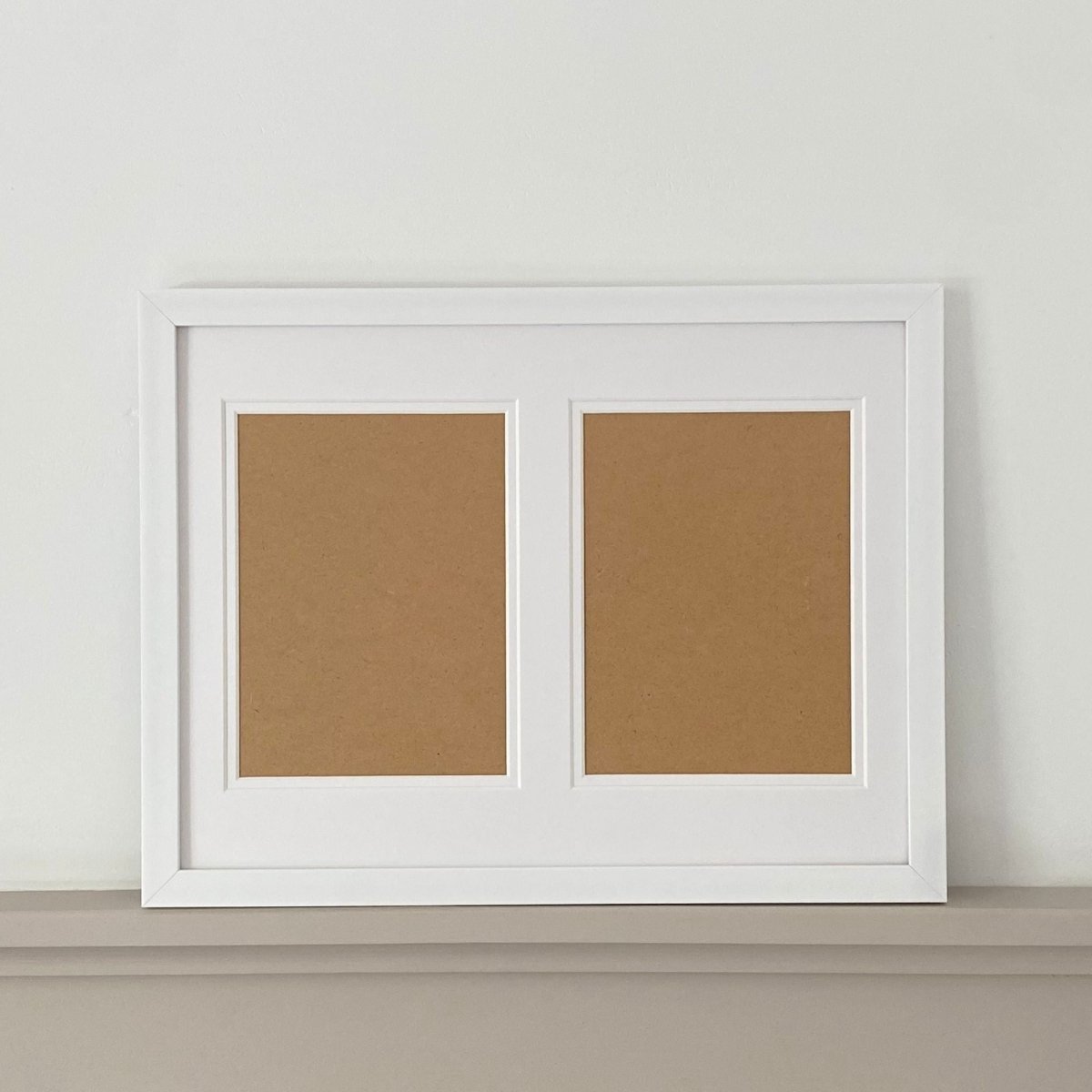 white landscape frame on grey shelf