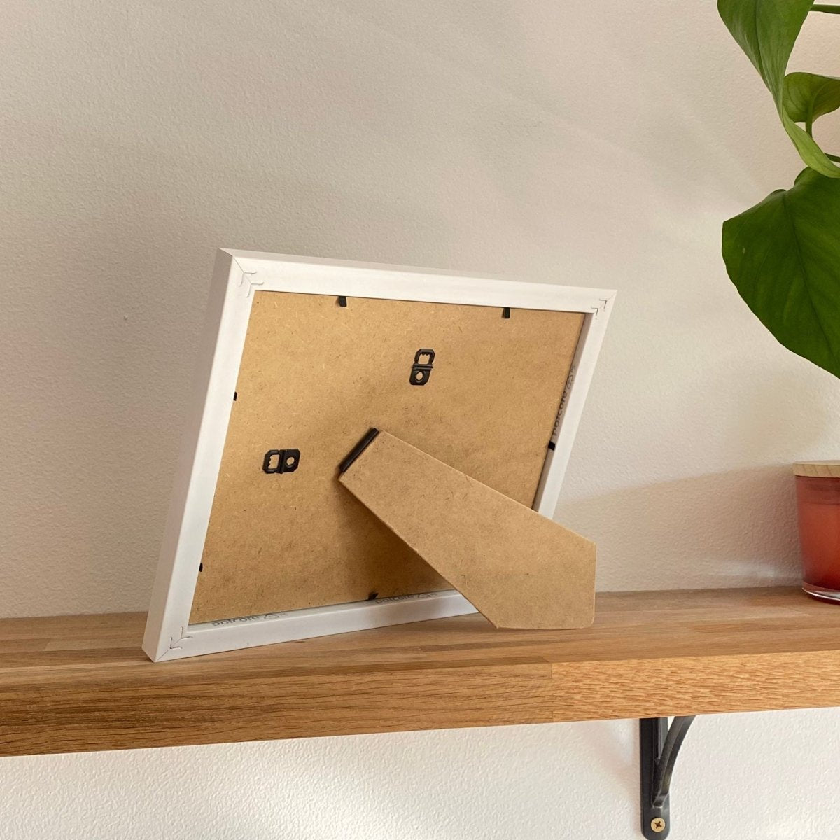 Back of one aperture white picture frame lifestyle photo-shot with home decor