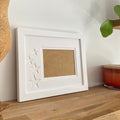 White 1-aperture star picture frame displaying empty opening
