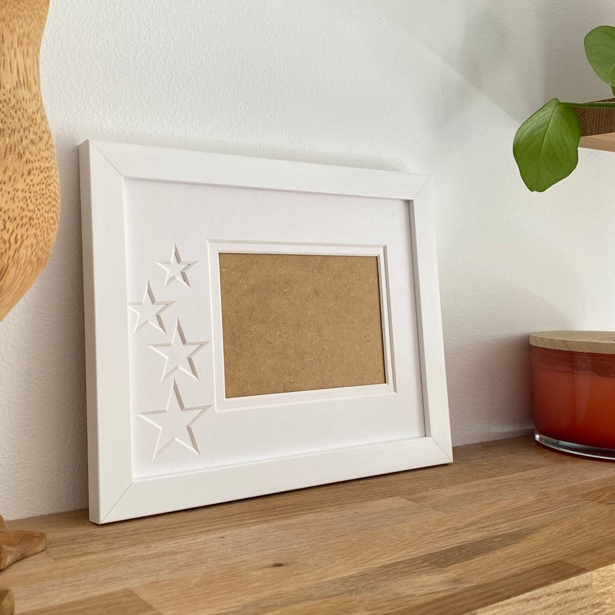 White 1-aperture star picture frame displaying empty opening
