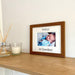 1st Grandson Brown picture frame on the shelf next to a white candle and diffuser