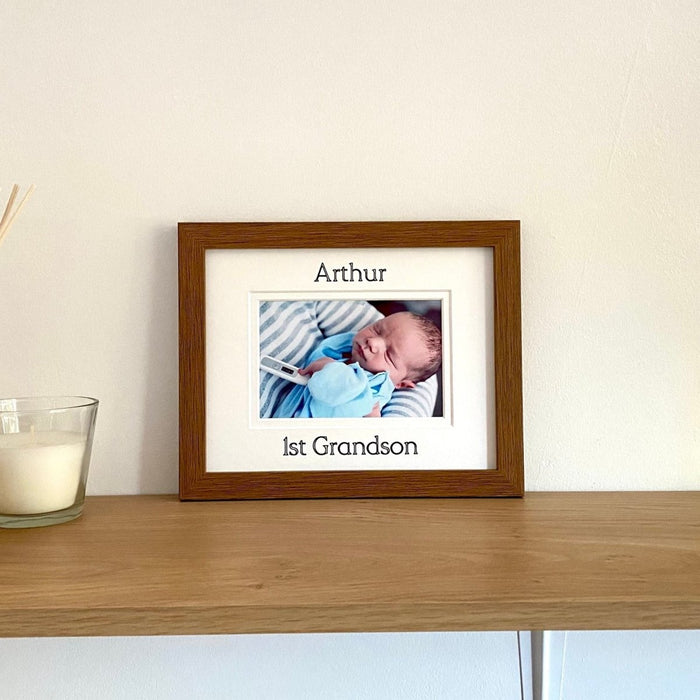 1st Grandson Brown picture frame on the shelf next to a white candle