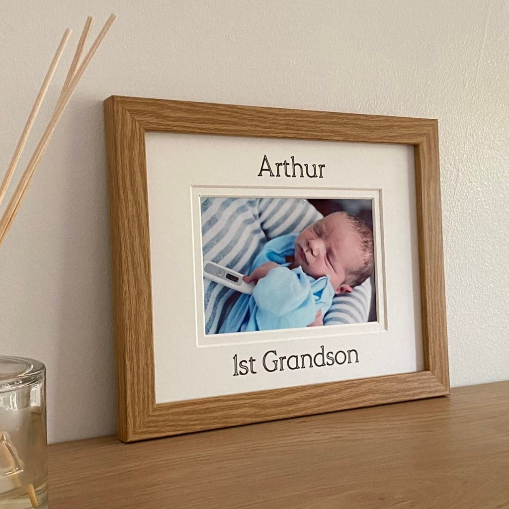 Light brown picture frame of first Grandson on shelf next to diffuser