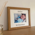 Light brown picture frame of first Grandson on shelf next to diffuser