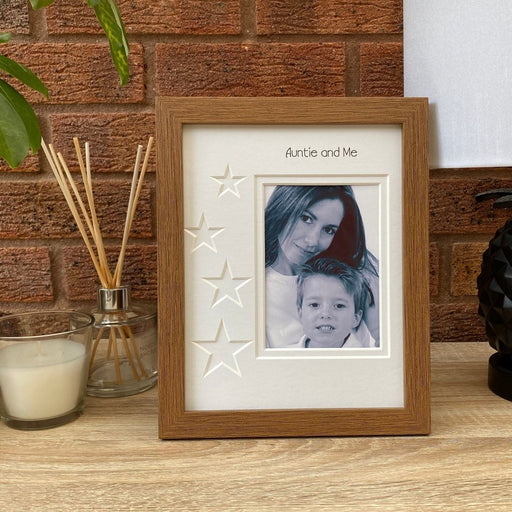Auntie and Me, Dark brown picture frame on the tabletop next to a white candle and a diffuser
