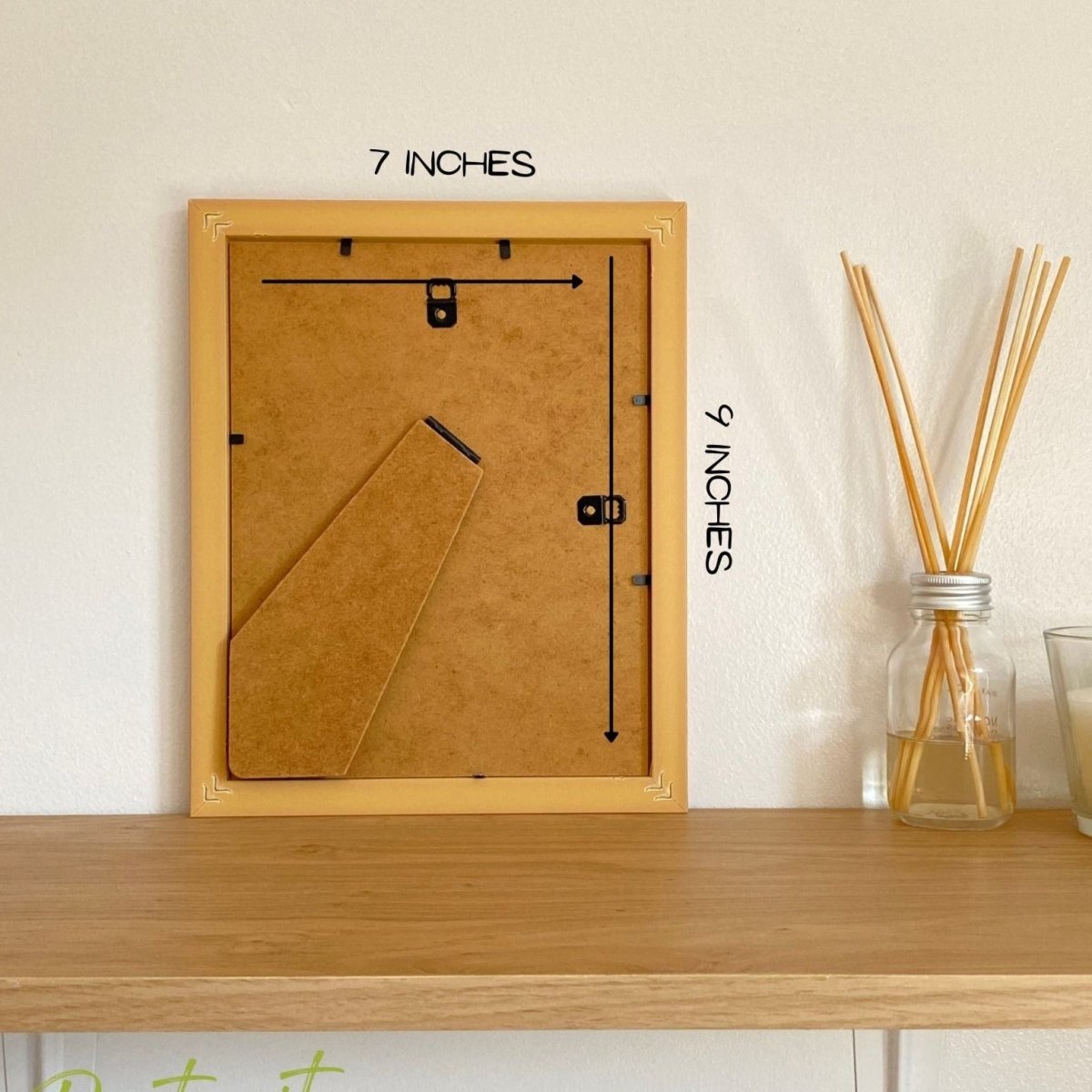 Back of 9 x 7 inches Portrait Frame on shelf next to a diffuser