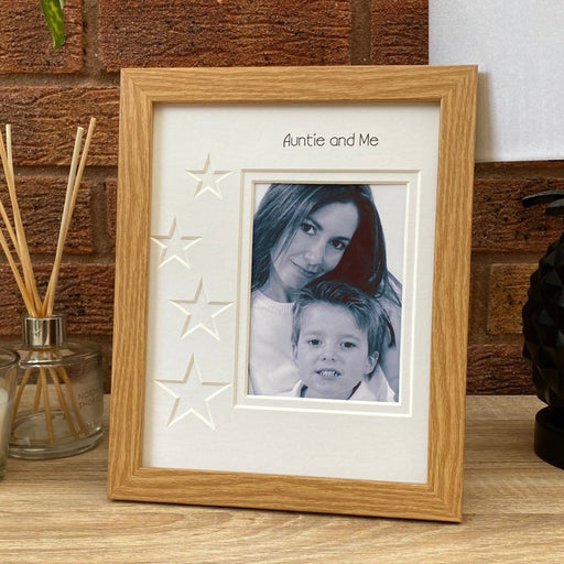 Portrait picture frame, a photo of an Auntie and young boy nephew on a tabletop next to a diffuser