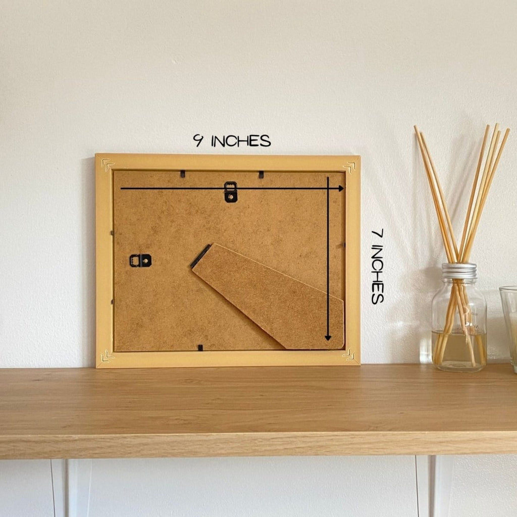 Back of a frame on the shelf next to a diffuser