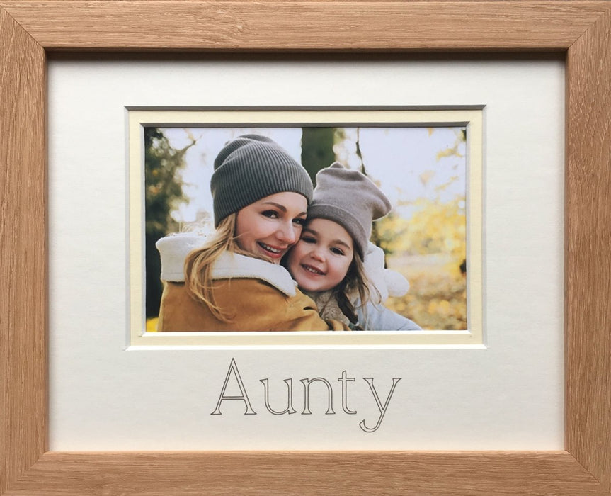 A photograph of an Auntie and her niece in a light brown photo frame