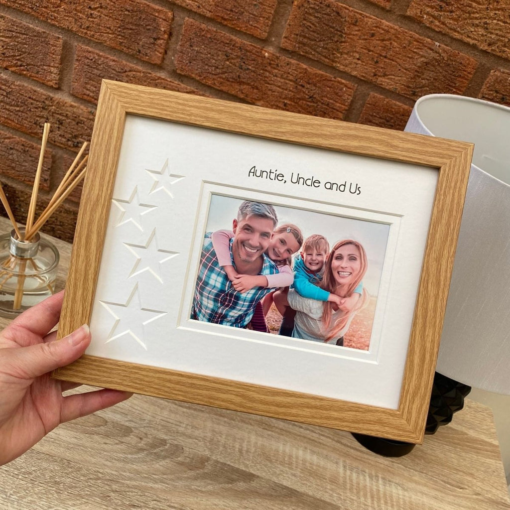 Holding a picture frame of a family by a lamp and a diffuser
