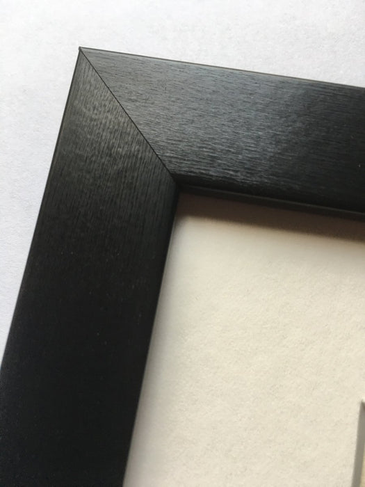 Corner of a black matt finish photo frame