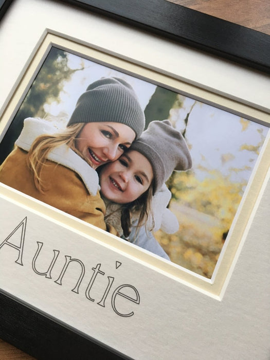 Landscape photograph of an Auntie and a girl in a black photo frame