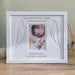 White Angel Baby Picture Frame on the tabletop next to a candle and diffuser