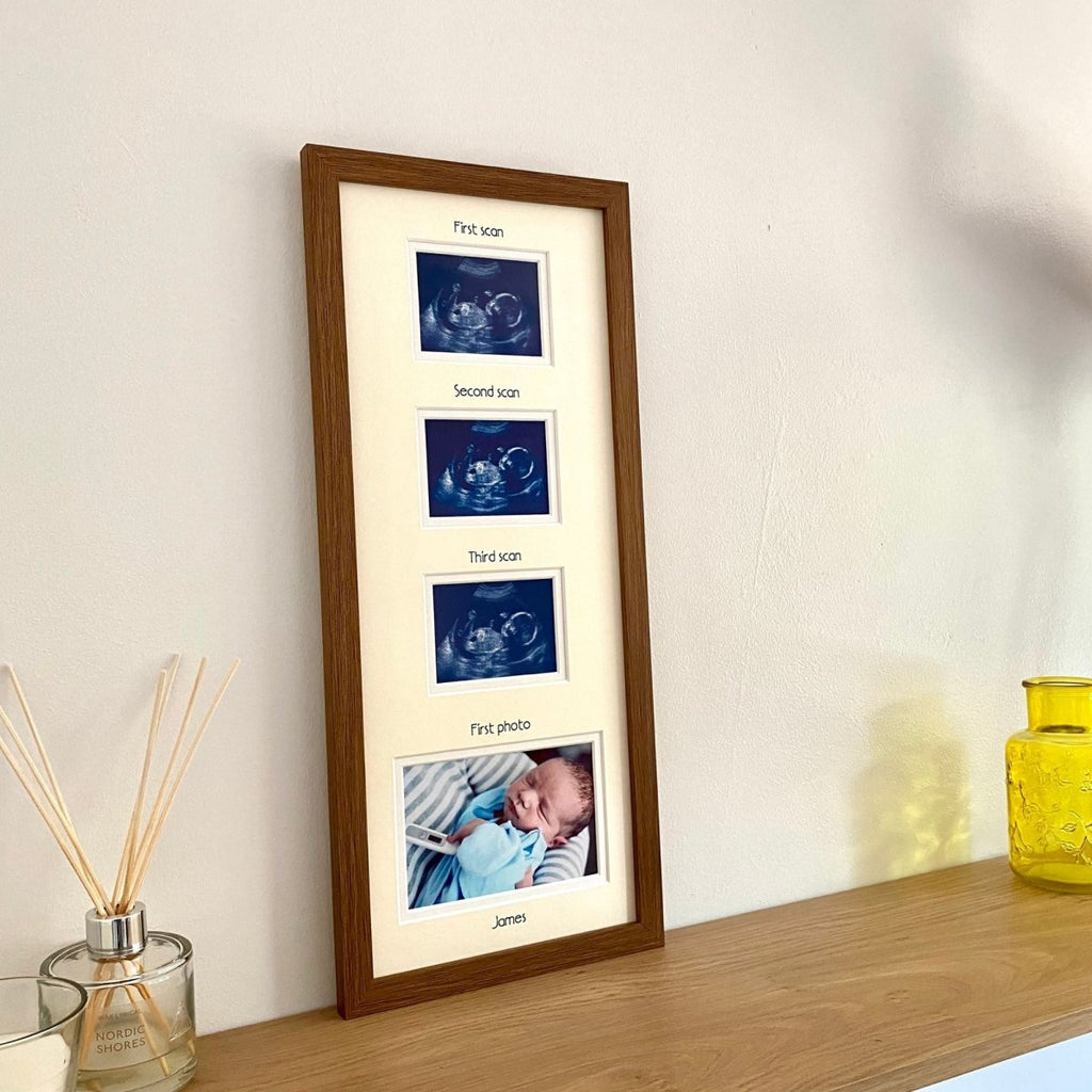 Multi-picture baby frame in dark brown standing on the shelf next to a diffuser 