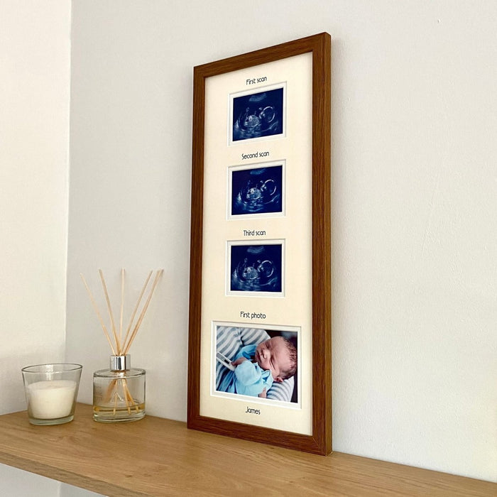 Multi-picture baby frame in dark brown resting on the shelf next to a diffuser and candle 