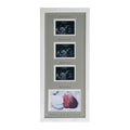 White frame with a grey picture mount showing scanned images and baby