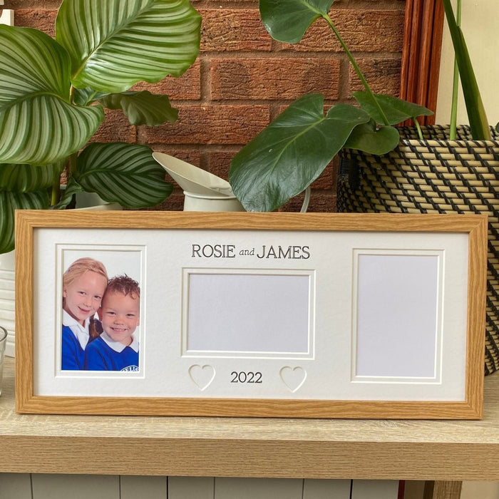 Light brown, multipicture School frame on tabletop next to green plants