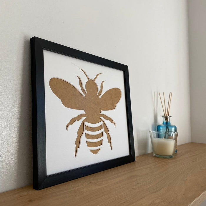 Black picture Bee Frame on shelf with a candle and diffuser