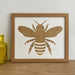Light brown, bee white single mount Frame on the shelf next to yellow glass pot
