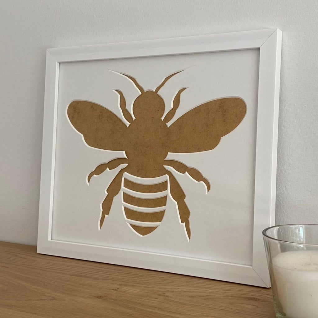 Bee Silhouette white frame on the brown shelf