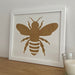 Bee Silhouette white frame on the brown shelf