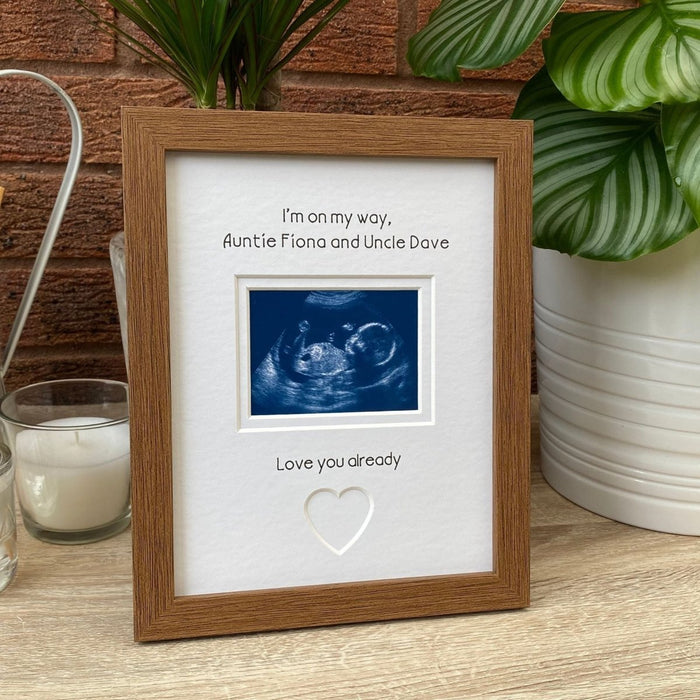 Auntie Uncle scan Picture frame next to white candle and plant