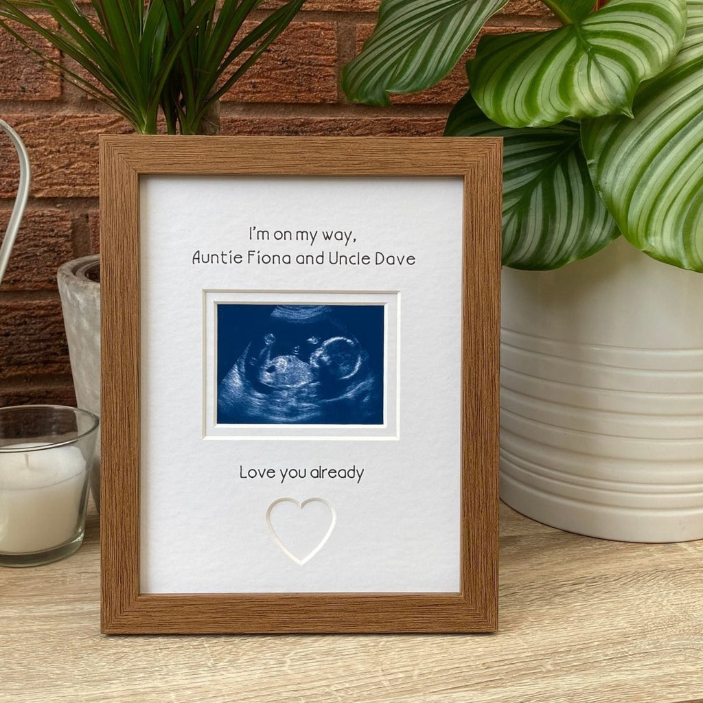 Auntie Uncle scan Picture frame next to white candle and plant