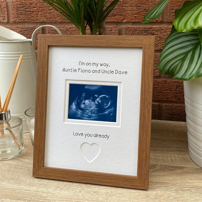 Auntie Uncle scan Picture frame next to white jug, diffuser and plant