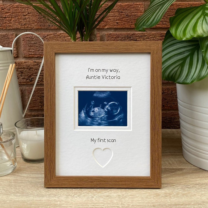 Auntie scan picture frame on tabletop next to a plant, diffuser and candle