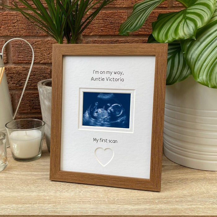 Auntie scan picture frame on tabletop next to a plant and candle
